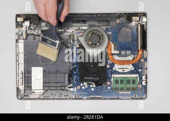 Cleaning a dusty laptop motherboard