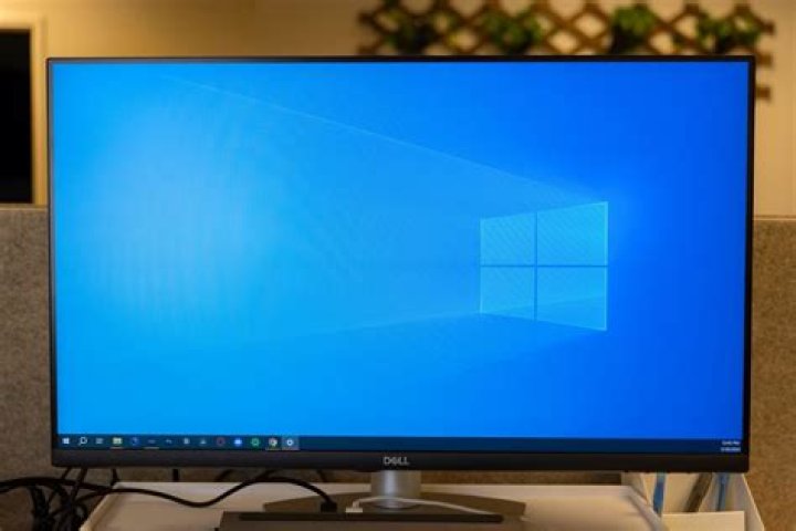 What could cause my computer's display to go darker suddenly?
